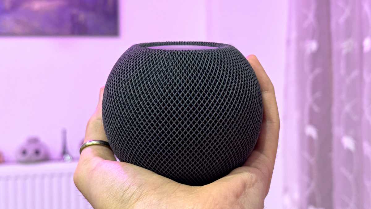 Apple Homepod mini held in hand